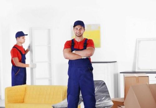 Professional movers carrying furniture for a home move in East London