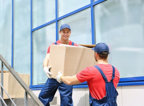 Man with van loading items for a local removal in Leyton