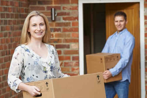 Moving team handling boxes and household items in Leyton