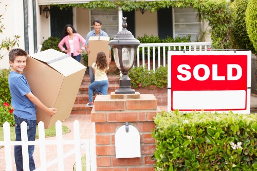 Professional movers handling office equipment for a Leyton business
