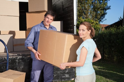 Professional movers handling household furniture carefully